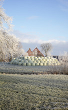 Stacked Up Fodder In Front Of Farm Building