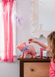 © Raymond Forbes LLC/Stocksy - Coin Deposit Piggy Bank