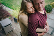 © Rob and Julia Campbell/Stocksy - Serious couple hugging together at home.
