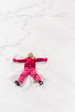 Child In Snow Making Snow Angel
