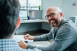 © FS Productions/Tetra Images - Smiling man sitting in office