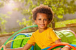 Happy curly black boy portrait on playground