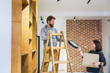 © Aleksandar Novoselski/Stocksy - Young couple moving in a new home