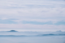 Layered Mountain Landscape With Clouds And Fog