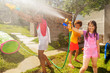 Girl and friends play water gun fight game outside
