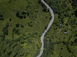 © guille Faingold/Stocksy - Curvy roadway in green highlands