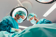 © MyMicrostock/Stocksy - Surgeons in the operating room