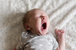 © L?a Jones/Stocksy - newborn baby yawning