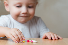 Baby Girl And Pills Left By Adults, Close Up