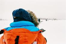 Anonymous Arctic Adventurers Riding Dog Sleds Through Nordic White Winter Landscape