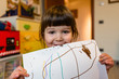 © Giorgio Magini/Stocksy - Proud Toddler Girl Showing her First Drawings