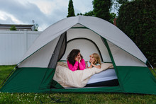 Child And Adult In Tent In Backyard
