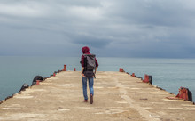 Traveler On A Pier In The Sea