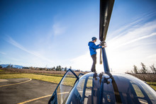 Mechanic Working On Helicopter Outdoors