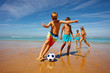 © Sergey Novikov - Children play soccer ball on a beach near the sea