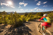 © Cavan Images - Mountain biker with motion blur riding on a trail in the mountains