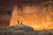 Two Women Doing Yoga Outdoors In The Desert At Sunrise