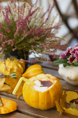 Poster - Coffee in pumpkin on a wooden table.