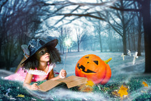 Girl In Witch Costume Cast Spells Over Big Pumpkin