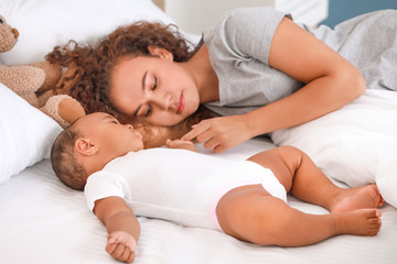 Sticker - Young African-American woman and her baby sleeping on bed