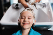 © hedgehog94 - Beautiful little girl at hairsalon. Hair washing.