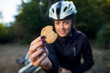 © Novak - Female cyclist eating integral biscuit