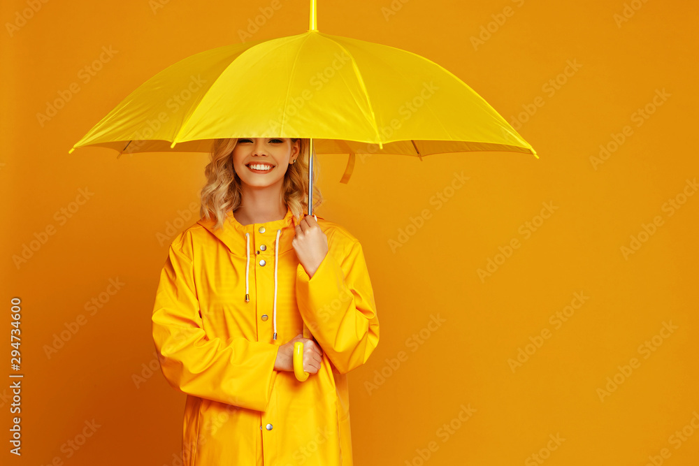 ng happy emotional girl laughing  with umbrella   on colored yellow background. - obrazy, fototapety, plakaty 