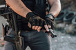 Close-up image of a mercenary with all kinds of weapon, close-up.