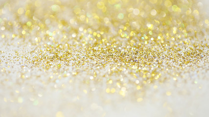 Wall Mural - Lights on gold with star bokeh background.Gold celebration background for anniversary, New Year Eve, Christmas, falling coins, wedding or birthday