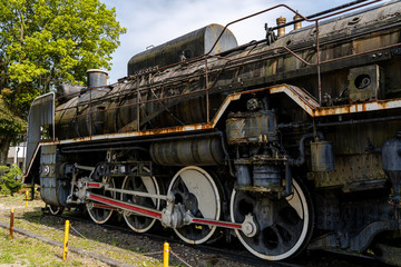 close up old black stream train demonstrate    parking on the track , the train show of vintage retro style from old century. 