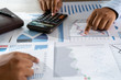 © onephoto - businessman working using a calculator finance accounting concept achievement to balance man assistant accounting