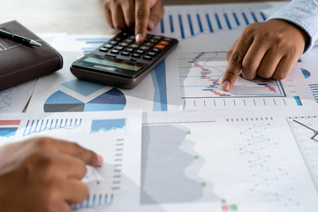 Wall Mural - businessman working using a calculator finance accounting concept achievement to balance man assistant accounting
