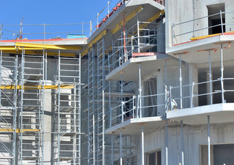 close on concrete facade  with scaffolding of a residence in building on work place