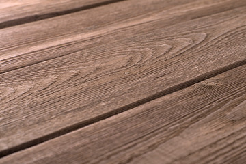 Wall Mural - Side view of old rustic dilapidated brown wooden planks with shallow depth of field. Creative modern trendy texture background.