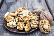 Walnut Kernels Lie In A Bowl On A Rustic Old Wooden Table. Fresh Walnuts.