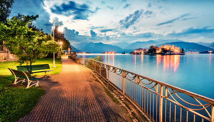 Wall Mural - Splendid evening cityscape of Stresa town. Wonderful summer susnset on Maggiore lake with Bella island on background, Province of Verbano-Cusio-Ossola, Italy, Europe. Traveling concept background.