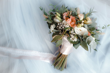 bouquet of roses on the wedding dress