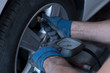 a car mechanic is controlling tire pressure
