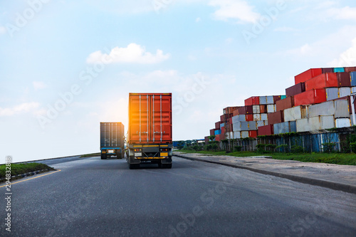 Back view of Red Container truck in ship port Logistics.Transportation industry in port business concept.import,export logistic industrial Transporting Land transport on Port transportation storge