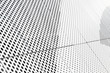 canvas print picture - Diagonal view of metall grilles and round holes in metal surface, perforated panels close-up