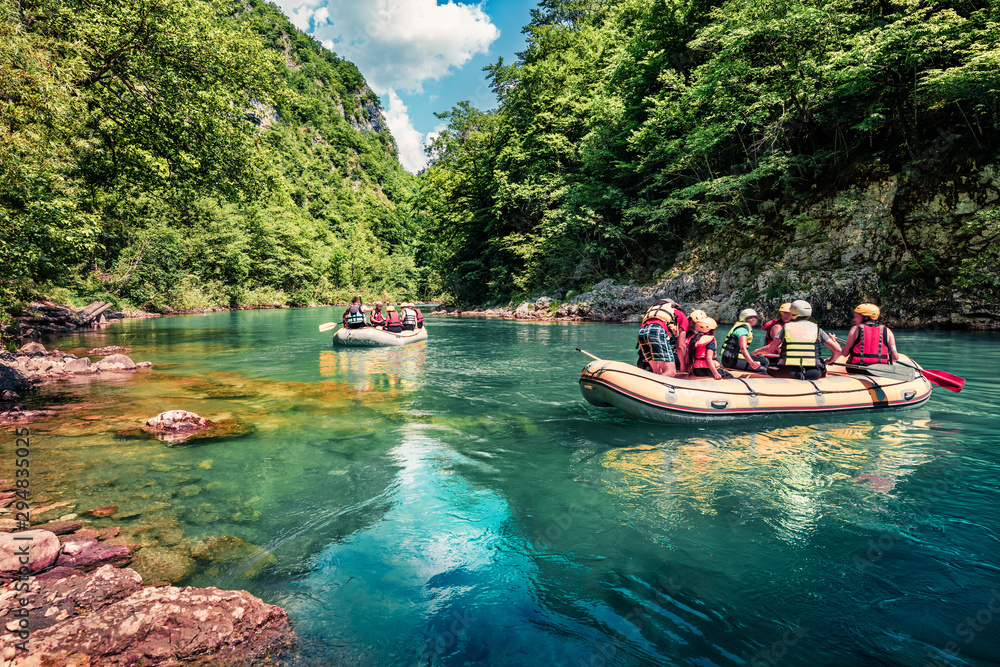 Excursions on inflatable boats along the river Tara. Exiting summer view of Tara canyon, Montenegro, Europe. Beautiful world of Mediterranean countries. Active tourism concept background. - obrazy, fototapety, plakaty 