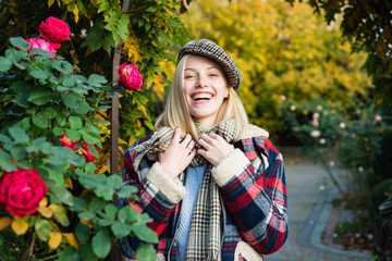 Magnificent white girl in casual clothes is smiling and posing in autumn park. Concept of soft trendy clothes in the autumn holidays.