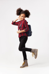 Wall Mural - Cute smiley girl in chequered shirt with backpack