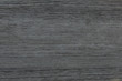 Dark grey wood texture background surface with natural pattern and horizontal strokes.