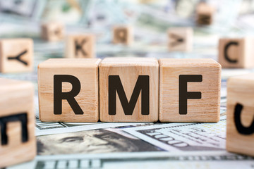 Wall Mural - RMF - acronym from wooden blocks with letters, abbreviation LTF Long-Term Equity Mutual Fund and RMF Retirement Mutual Fund concept, random letters around, money background