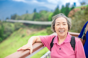 Sticker - Asian Senior woman hiking in the mountain park