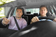 © Syda Productions - driver courses and people concept - car driving school instructor teaching young man to drive