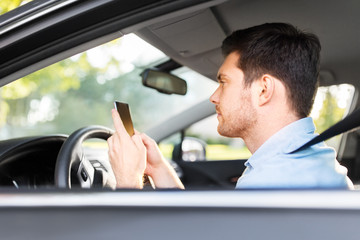 Sticker - transport, vehicle and technology concept - smiling man or driver driving car and using smartphone