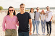 © Syda Productions - valentine's day, relationships and people concept - happy couple with group of friends on beach in summer