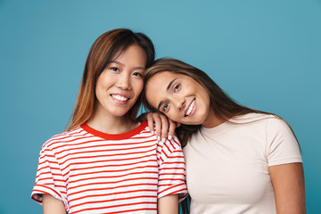 Wall Mural - portrait of multinational young women smiling and looking at camera